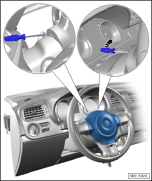 VW factory diagram showing a screwdriver inserted through slots at the back of the steering wheel to release the airbag spring clips on each side